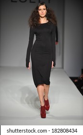 Attractive Fashion Model Walking The Runway Wearing Elegant Black Dress. 