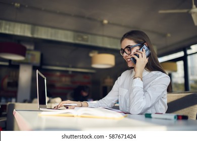 Attractive Female Administrative Manager Of Restaurant Arranging Working Meeting With Staff Members To Discuss Plans For Month Through Telephone Conversation Sitting In Food Court Using Technology