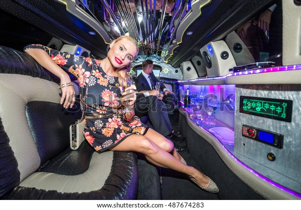 Attractive Female Celebrity With Champagne\
Flute In Limousine