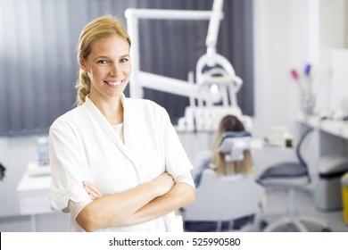 Attractive Female Dentist Posing In Modern Dental Office