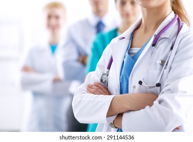 Attractive female doctor in front of medical group . - Powered by Shutterstock