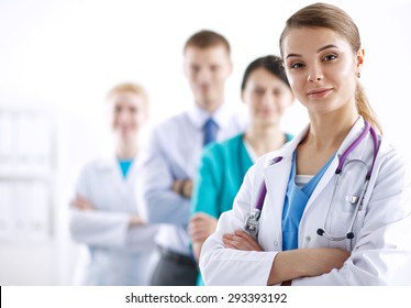 Attractive female doctor in front of medical group . - Powered by Shutterstock