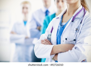 Attractive female doctor in front of medical group - Shutterstock ID 492726310
