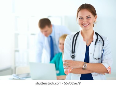 Attractive female doctor in front of medical group - Shutterstock ID 557085679