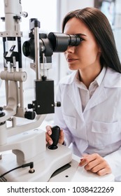 Attractive Female Doctor  Ophthalmologist Is Checking The Eye Vision Of Patient In Modern Clinic. Doctor And Patient In Ophthalmology Clinic.