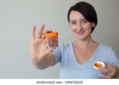 Attractive Female Doctor  Shallow Depth Of Field Hand Holding Orange Medicines 