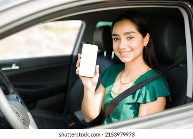 Attractive Female Driver Showing Her Smartphone Screen And Ready To Pick Up A Passenger On A Ride Share App