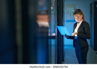Attractive female employee working in internet server room