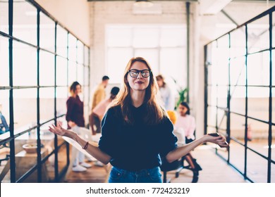 Attractive female in eyeglasses meditating during working process in coworking space finding inspiration, happy young woman with clothes eyes enjoying job with calmness and concentrated on idea
