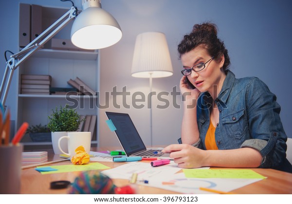 Attractive Female Freelancer Communicating On Telephone - 