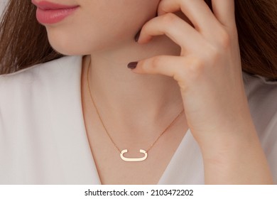 Attractive Female Model With Initials Silver Necklace Around Her Neck. Jewelry Photo For E Commerce, Online Sale, Social Media.