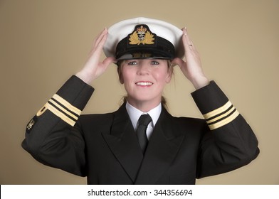 Attractive Female Naval Officer Holding Her Uniform Hat