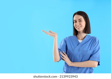 Attractive Female Trainee Nurse On Blue Background