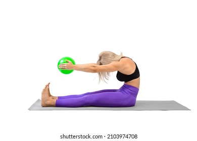 Attractive fit woman practice sitting forward bend exercise with a small green rubber ball in hands, isolated on white.
