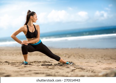 Attractive Fit Woman Stretching  On Beach, Outdoor Workout