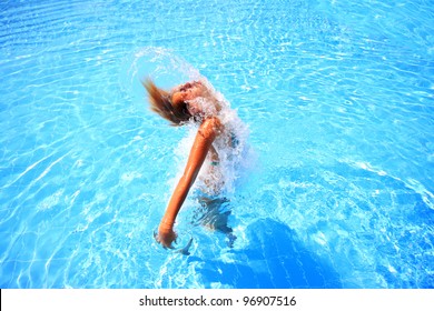 Attractive Fit Young Tanned Girl Throwing Wet Hair Back In Swimming Pool