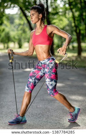 Similar – Fit muscular woman working out in a park