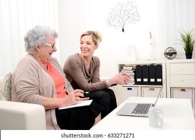 Attractive Forty Years Old Woman Helping With Computer Her Mother For Internet Search , Eighty Years Old Senior Woman At Home