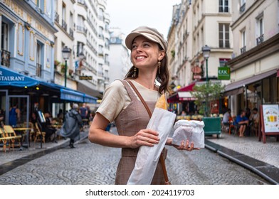 Attractive girl with French baguette on the street