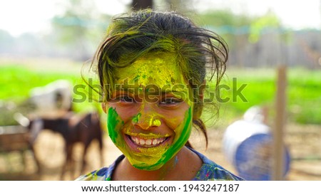 Attractive Girl in green colors Holi. Holi facial shot on spring color festival of Holi. Holi celebration concept.