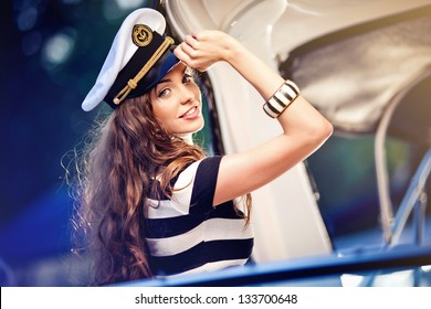 Attractive girl on a yacht at summer day