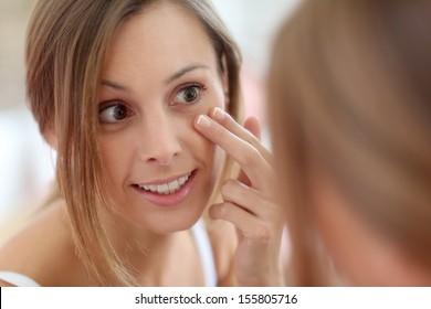 Attractive Girl Putting Anti-aging Cream On Her Face