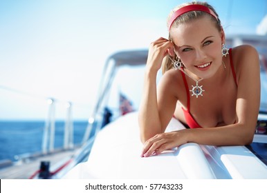 Attractive girl sailing on a yacht on summer day