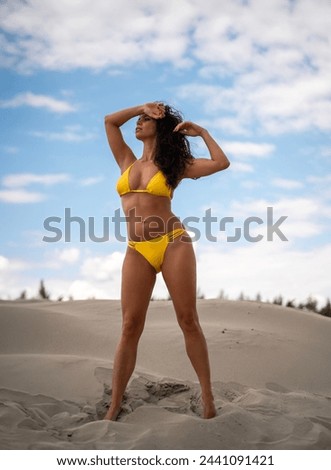 Attractive girl in yellow bikini posing in the desert 