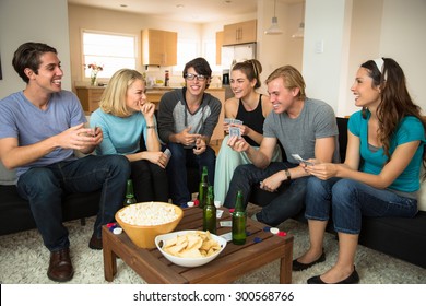 Attractive Group Of Friends At Home Game Night Party Popcorn Beers Card Playing Poker