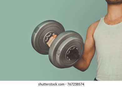 Attractive Guy Lifting Weights. Not A Professional Athlete Shakes Muscle Large Dumbbells. Slim Adolescent Body. Home Exercises For Weight Gain. Average Man, Average Person