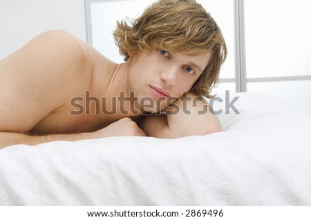 Attractive guy on bed.