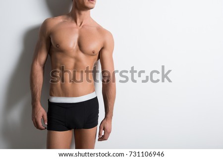 Attractive guy is posing shirtless