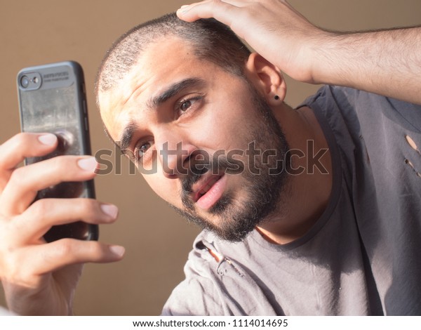 Attractive Guy Short Hair Checks His Royalty Free Stock Image