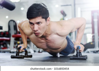 Attractive Handsome Asian Young Men Workout With Push Up Bar In Gym Focus On Muscle Feeling So Strong And Powerful,Bodybuilder Concept