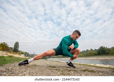 Attractive And Handsome Guy Is Streching His Legs And Warming Up, Low Angel