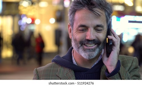 Attractive Handsome Older Man, Grey Hair Beard, Talking On Smart Mobile Cell Phone On Street In New York City. Successful Hipster Urban Businessman.