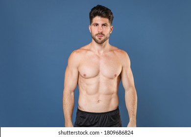 Attractive handsome young bearded fitness sporty strong man bare-chested muscular sportsman isolated on blue background studio portrait. Workout sport motivation lifestyle concept. Looking camera - Shutterstock ID 1809686824