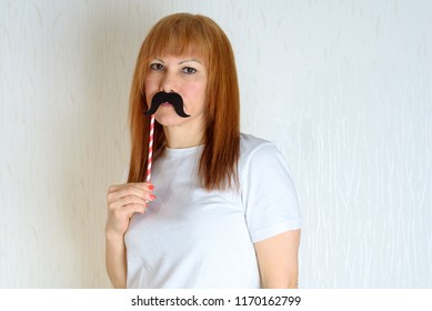 Attractive Happy Middle Aged Woman Having Fun With A Fake Moustache On Stick. Senior  Female In Period Menopause. Lifestyle, Women's Health Concept : Playful  Mature Ready For Party. Impostor Syndrome