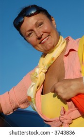 Attractive, Happy Senior Standing By Her Car Right After Retiring.  Yay, Retirement!