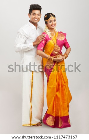 Attractive happy south Indian couple in traditional dress 