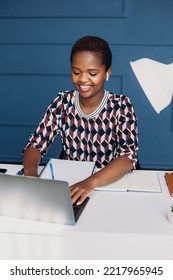 Attractive Happy Stylish African Black Woman Using Laptop Computer At Home Office. Business App. Close-up Of A Charming, Calm, Dark-skinned Curly Haired Woman