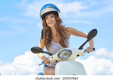 Attractive Happy Woman On A Scooter