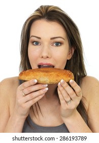 Attractive Happy Young Woman Eating A Baked Cornish Pasty