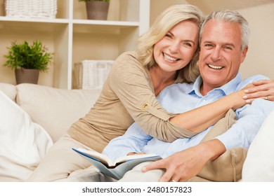 Attractive healthy senior man woman couple at home smiling reading a book - Powered by Shutterstock