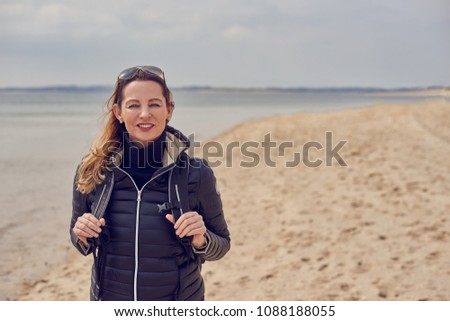 Pretty healthy woman enjoying a hike on a beach