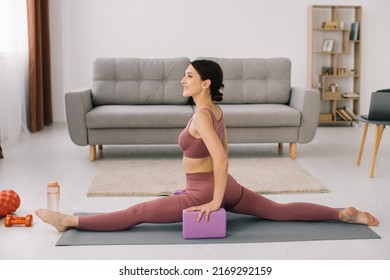 Attractive And Healthy Young Woman Sat Down On The Twine At Home