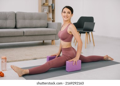 Attractive And Healthy Young Woman Sat Down On The Twine At Home