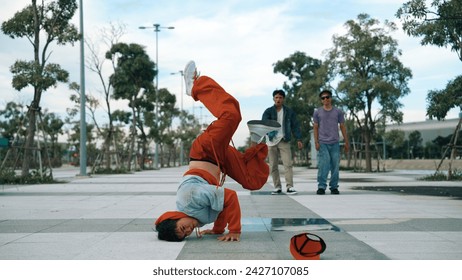 Attractive hipster doing b-boy dancing with multicultural friend. Professional handsome break dancer doing freeze pose while enjoy b-boy dancing. Modern lifestyle. Outdoor sport 2024. Sprightly. - Powered by Shutterstock