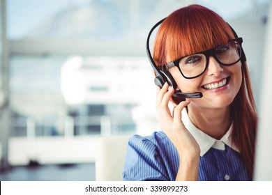 Attractive Hipster Woman With Headset In Her Office