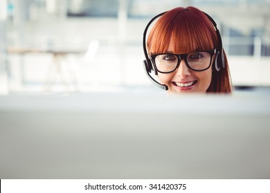 Attractive Hipster Woman With Headset In Her Office